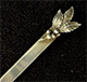 This bookmark was made in the US by Unger Bros. It is marked with the makers hallmark and Sterling 925 Fine. It a leaf design on top. This bookmark was sold from the 1904 Unger Bros. catalog.
