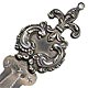 This bookmark is made in the US. It is only marked Sterling. The top has a fleur-de-lis with a ring on top for a tassel. The date is 1900 - 1910.