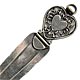 This bookmark is American made by The Napier Company. It is marked Napier Sterling. The top of the bookmark is in the shape of heart. The date is sometime after 1922.
