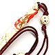 This bookmark is made in Hong Kong sometime in the 1930's or 1940's. It is in the shape of a woman on the top with two carved beads and a carved elephant at the end of the cord. It is made of either bone or ivory.