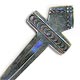 This bookmark was made in the US by an unknown manufacturer. It is marked only Sterling. It is in the shape of a cross with a diamond on top and the front is hand stamped. The date is unknown.