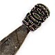This bookmark was made possibly in South America or New Zeland. The top of the mark is a man, possibly a Maori. It is marked 0900 on the back of the top. Date is unknown.