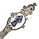 This bookmark was made in the US by an unknown manufacturer. It is marked only Sterling on the back of the small blade behind the top blade. The front has an enamel picture of woman, arms akimbo, and the name "Trilby". Date is 1900 - 1910.