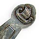 This bookmark was made in Norway between 1920 - 1940. It is marked 830S and the letter H. The top is a picture of a Norse ship.