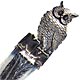 This bookmark was made in the US by an unknown manufacturer. It is marked sterling on the bottom of the larger blade. It is an owl sitting on a book. The smaller blade is two crossed feathers. The date is 1890 - 1900. 