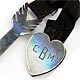 This bookmark was made in the US by an unknown manufacturer. It is marked Sterling and has a number AT180112. It is an arrow and a heart with a ribbon in between, where the heart is a clip that attaches to the binding and the arrow marks the page. The date is 1930 - 1950.