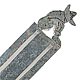 This bookmark was made in Mexico in the 1980s. It is marked Sterling Mexico and is a figural man sitting with a sombrero.