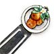This bookmark was made in the US by F.A. Hermann Co. It is marked with the makers mark and sterling. The top is enameled oranges and leaves with an orange blossom   surrounded by a circle of white enamel. The date is 1900 - 1910.
