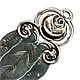 This bookmark was made in Sweden by an unknown manufacturer. It is marked with the Swedish hallmarks and the date letter V7 for 1922. It is in the shape of a leaf with a flower on top. It is very similar to the Georg Jensen bookmark number 103.