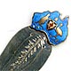 This bookmark was made in Australia by an unknown manufacturer. It is marked with a unicorn hallmark and STG. SILVER. The top of the bookmark is an enamel figural in shape of the continent of Australia with a kangaroo and emu on either side of a shield. The date is 1920 - 1930.