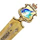 This bookmark was made in the US by an unknown manufacturer. It is marked only sterling on the back and is finished in a gold wash. The top is an enameled fish within a shield. The blade is marked Bermuda. The date is 1960 - 1970.  