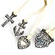 This bookmark was made in the US by an unknown manufacturer. It is marked sterling. It is a multi-page bookmark with three charms attached to ribbons. The charms are a cross, an anchor and a heart representing faith, hope and charity. The top is a piece of silver with the letters "i h s". This bookmark was sold in the 1901 Daniel Low & Co. Silver Catalog. The date is 1900 - 1910.  