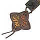 This bookmark was made in Italy by an unknown manufacturer. It is marked made in Italy on the back. It is a leather bookmark with an embossed design that is hand painted. The date is unknown.  