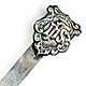 This bookmark was made in the US by an unknown manufacturer. It is marked only sterling. The top is a shield with the letters ihs. The date is 1900 - 1904.