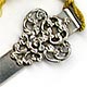 This bookmark was made in the US by an unknown manufacturer. It is marked sterling. The top a fancy art nouveau design, almost a filigree. It has a yellow silk tassel. The date is 1900 - 1910.