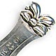 This bookmark was manufactured in Sweden. It is marked with the Swedish state marks and 830S. It has a figural flower on top. The front blade is marked 12/24 1938, no doubt a Christmas present for someone.