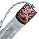 This bookmark was made by an unknown manufacturer possibly in Finland. It has a shield of silver and red enamel with a figural lion. The top has a blue silk tassel. The date is 1920 - 1930.