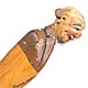 This bookmark was made in Italy by the Anri workshop. It is carved of wood and depicts a bald man in a brown suit. 